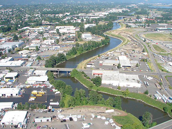 Aerial view of community along a waterway benefitting from levee protection